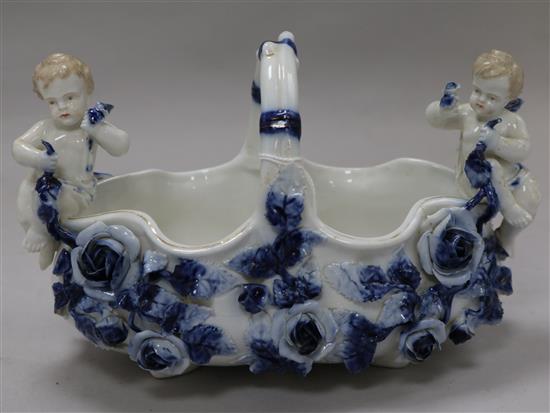 A Continental porcelain basket mounted with cherubs
